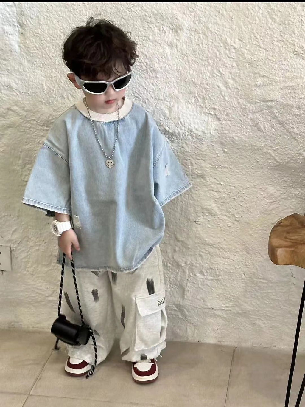 Children's denim short-sleeve top with distinctive ripped design