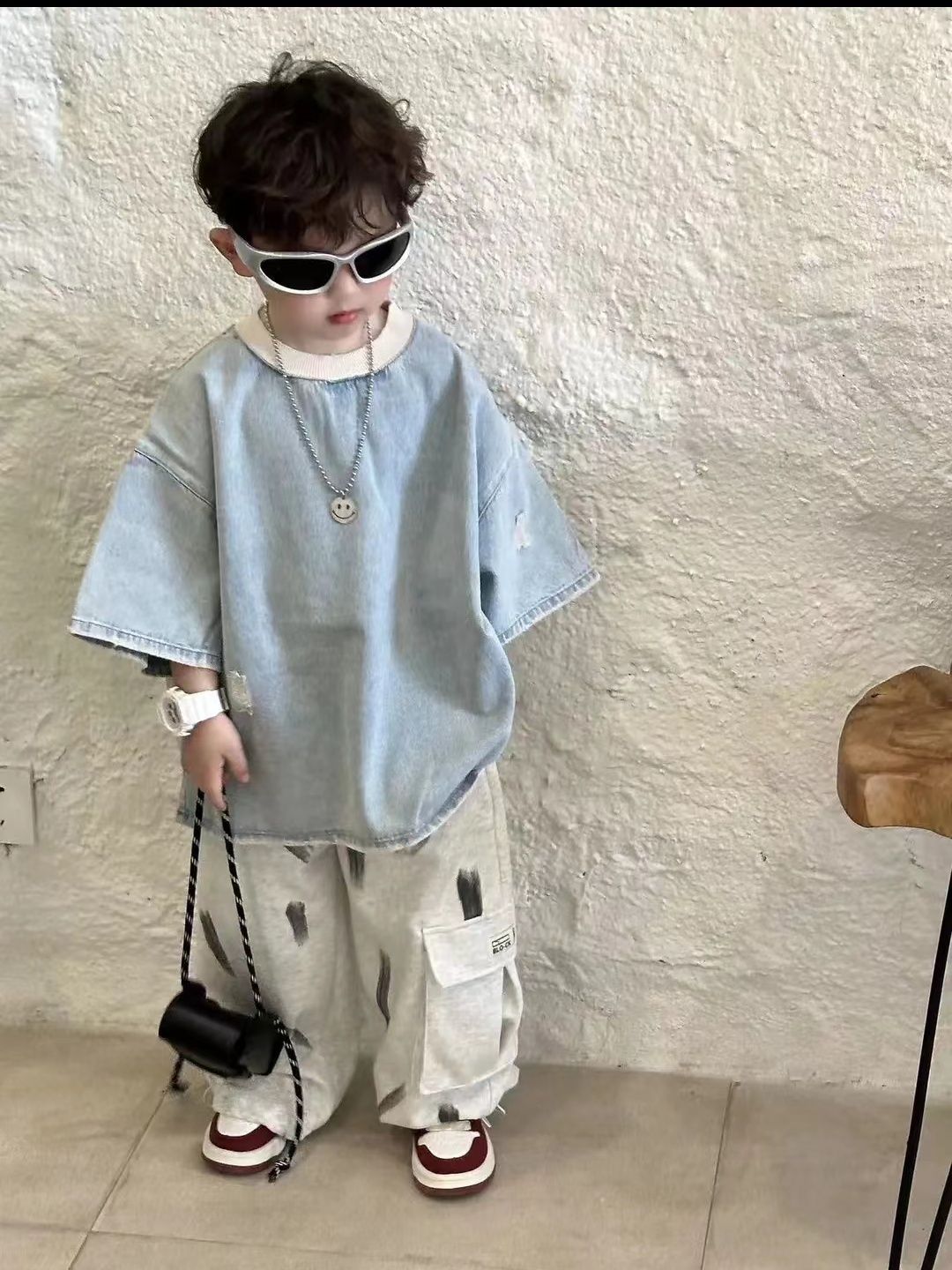 Children's denim short-sleeve top with distinctive ripped design