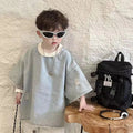 Children's denim short-sleeve top with distinctive ripped design